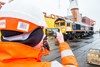 A member of staff photographs GBRf 66777, the final '66' to be unloaded at Newport Docks. 