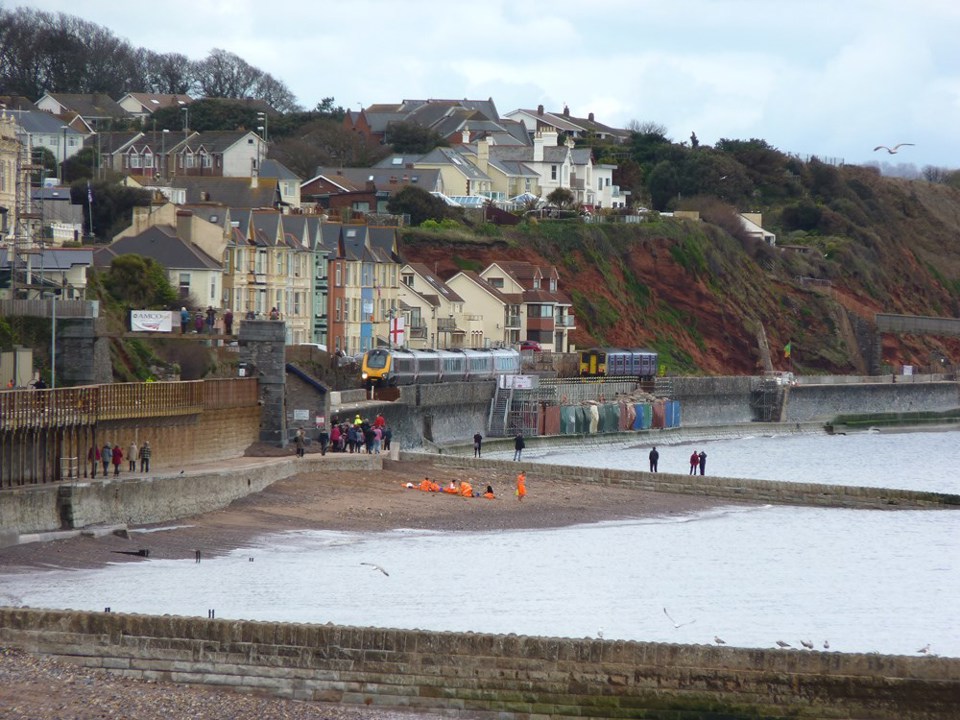 CrossCountry 221121 passes First Great Western 150234 at Dawlish on April 4 2014. RICHARD CLINNICK.